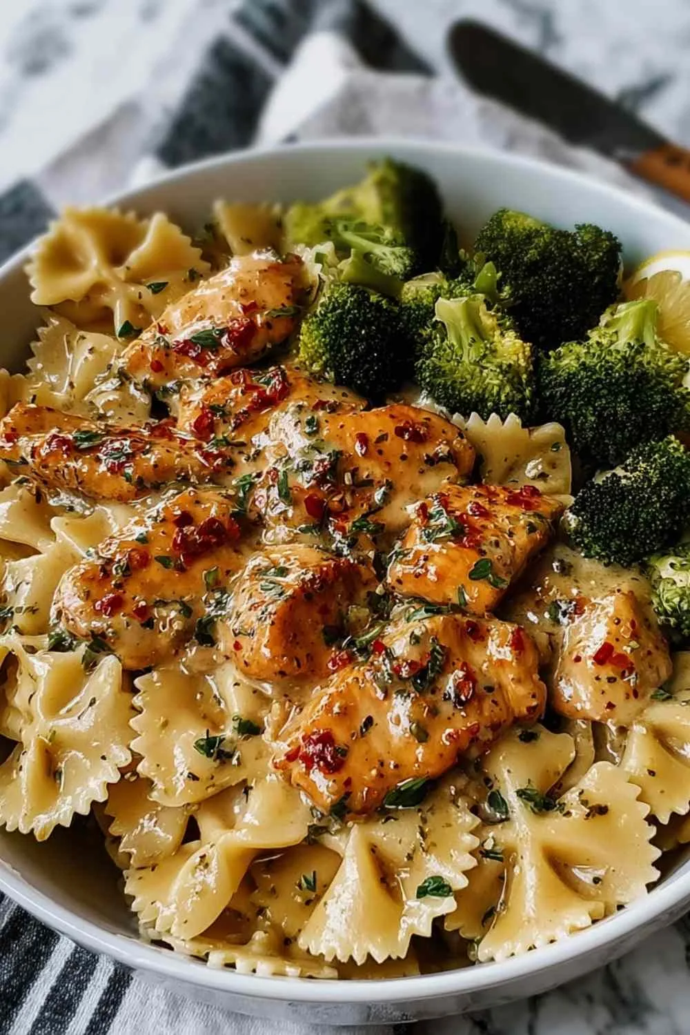 Cowboy Butter Lemon Chicken with pasta and broccoli in a skillet
