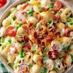Creamy Bacon Ranch Pasta Salad in a large white bowl with crispy bacon and fresh herbs