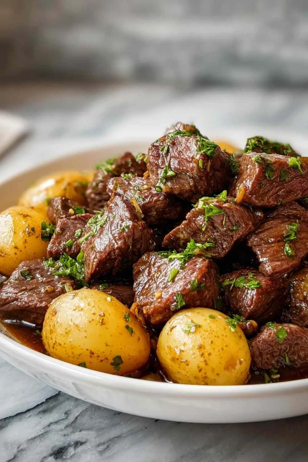 Crockpot Garlic Butter Beef Bites with Potatoes in a slow cooker