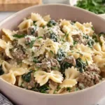 Crockpot Ground Beef Pasta in a white bowl showing creamy sauce and pasta
