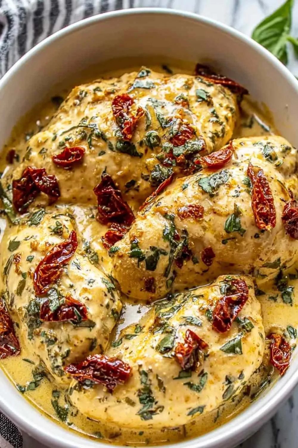 Crockpot Marry Me Chicken with creamy parmesan sauce and sun-dried tomatoes in slow cooker