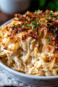 French onion chicken orzo casserole bubbling in a skillet with golden melted cheese