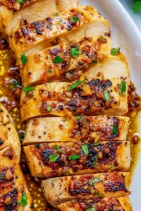Garlic Butter Chicken cooking in a cast iron skillet with golden crust.