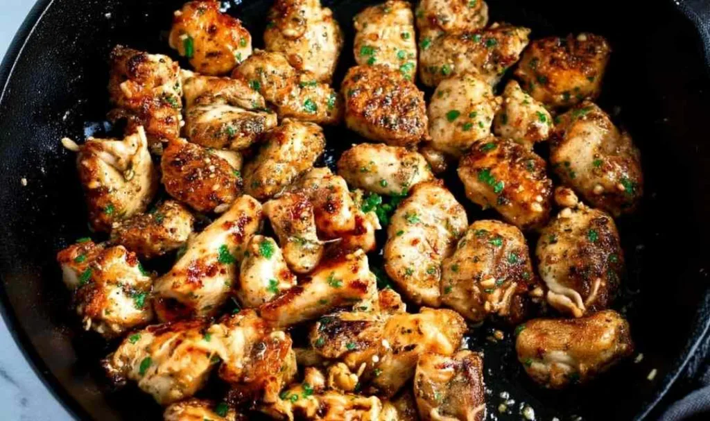 Golden Garlic Butter Chicken Bites in a cast iron skillet