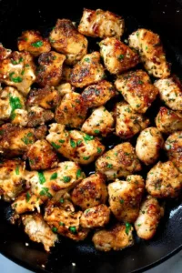 Golden Garlic Butter Chicken Bites in a cast iron skillet