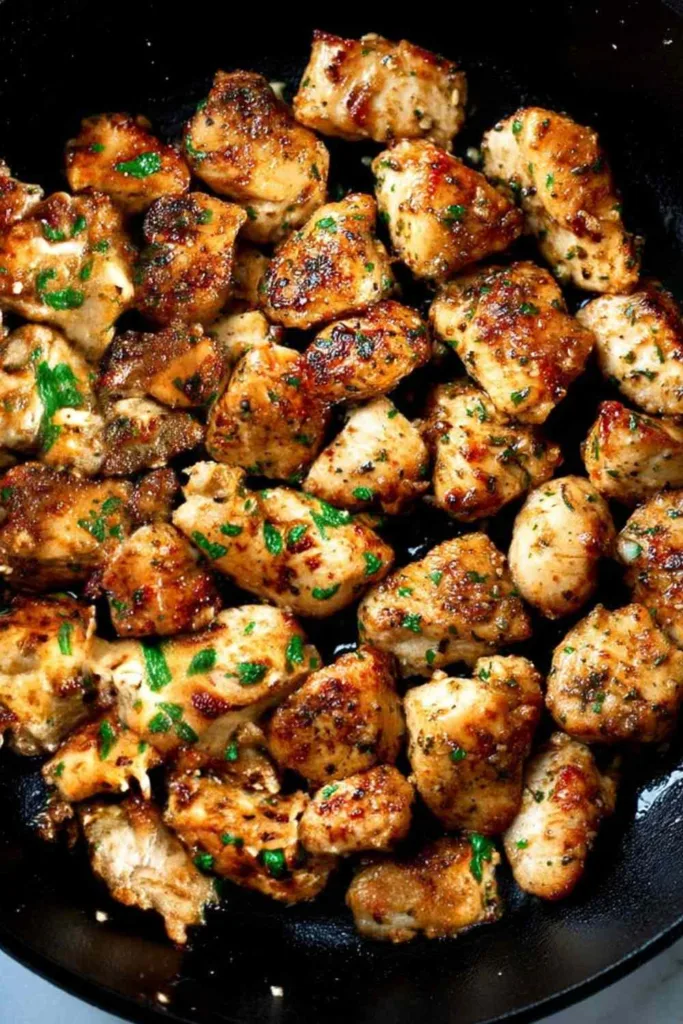 Golden Garlic Butter Chicken Bites in a cast iron skillet