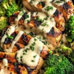 Grilled Chicken and Broccoli Bowls with Creamy Garlic Sauce on a wooden table