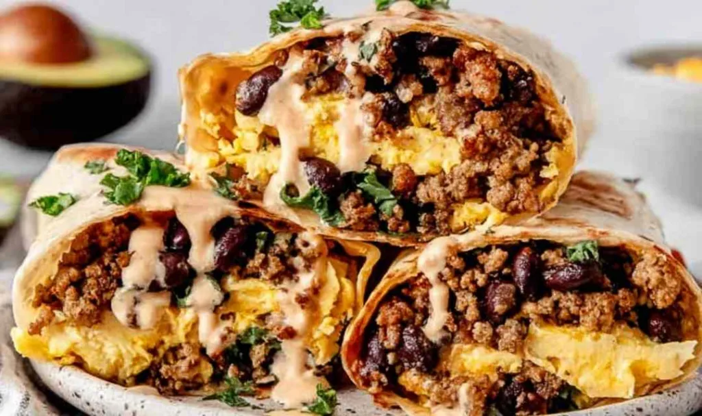 High Protein Breakfast Burrito cut in half showing egg and bean filling.