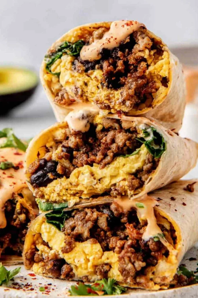 High Protein Breakfast Burrito cut in half showing egg and bean filling.