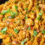 High Protein Chicken Fajita Pasta in a skillet with fresh parsley.