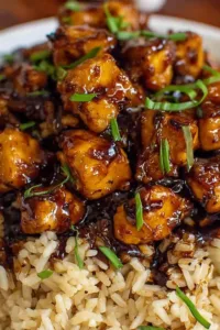Honey BBQ Chicken Rice Recipe served in a cast iron skillet topped with green onions.