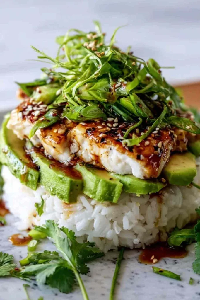 Honey Lime Chicken Avocado Rice Stack in a white bowl with grilled chicken slices and fresh avocado