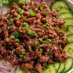 Korean Ground Beef with Cucumber Salad in a cast iron skillet.