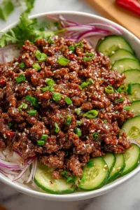 Korean Ground Beef with Cucumber Salad in a cast iron skillet.