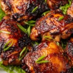 Roasted miso chicken thighs with caramelized glaze on a lined baking sheet