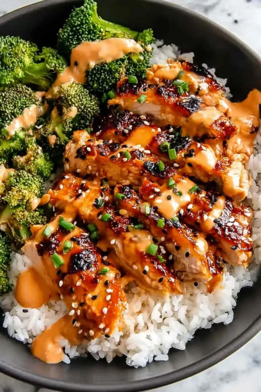 Sticky Chicken Rice Bowls in white bowl with sesame seeds and green onions