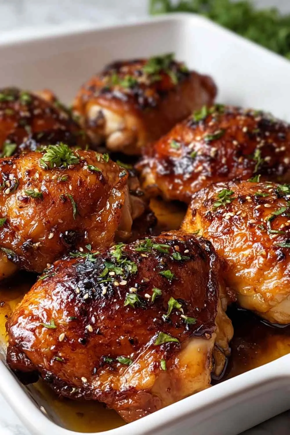Sticky baked chicken thighs with caramelized balsamic glaze in a baking dish