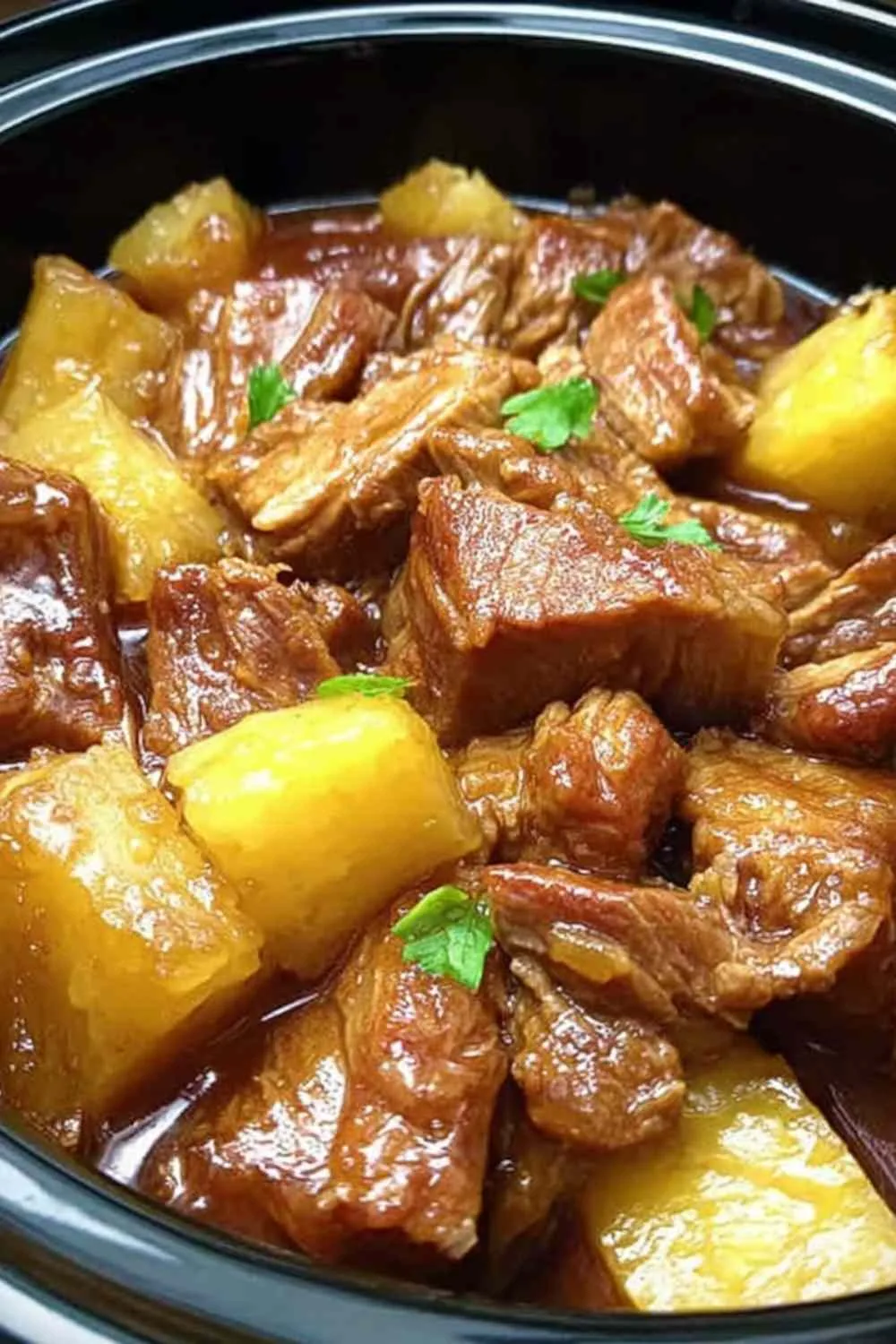 Slow cooker pineapple pork served over jasmine rice with green onion garnish