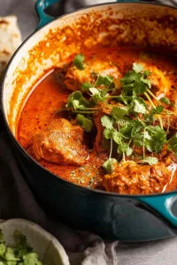 African Chicken Curry Kuku Paka served in a bowl with basmati rice and fresh cilantro