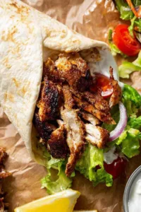 Chicken Shawarma Middle Eastern served in warm flatbread wraps with tomato lettuce and lemon yogurt sauce