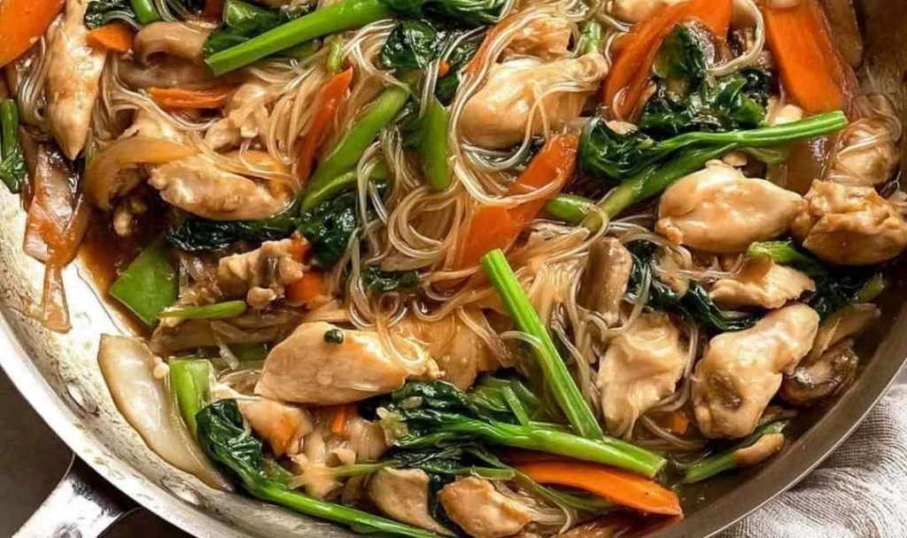 chicken stir fry chop suey in a wok with glossy Chinese brown sauce