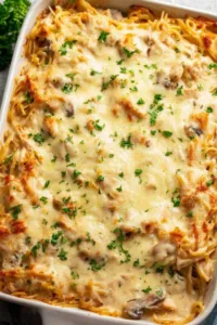 Chicken Tetrazzini pasta bake bubbling golden in a 9x13 pan fresh from the oven