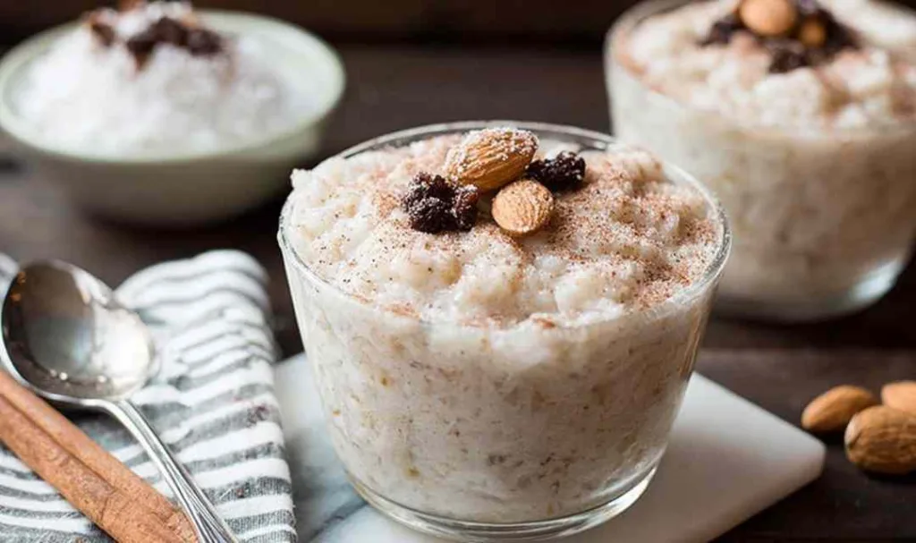 Ingredients for slow cooker coconut rice pudding including rice and coconut milk