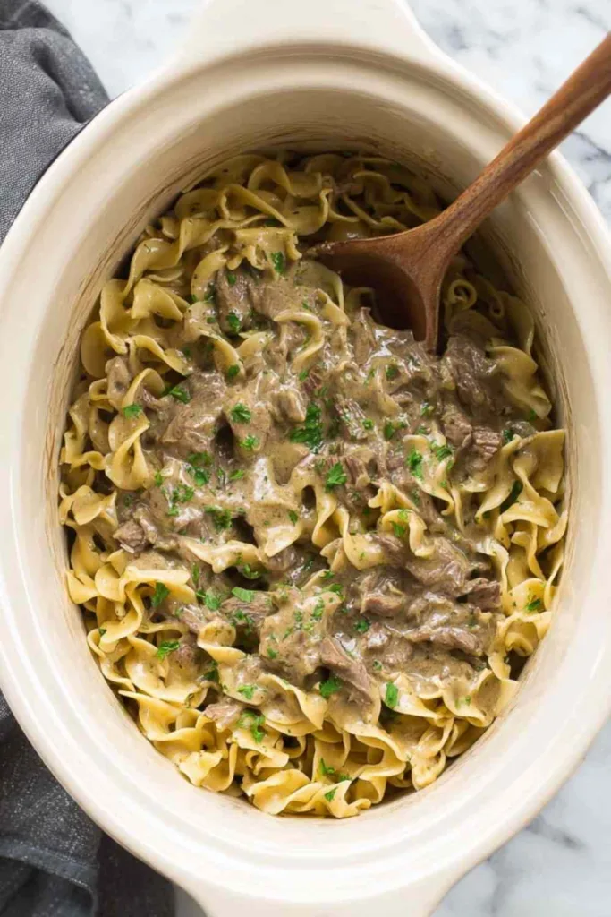 crock pot beef and noodles in slow cooker overhead view