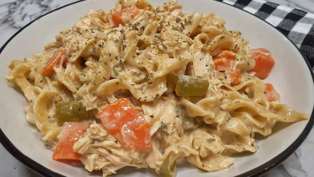 Crockpot creamy chicken and noodles in a white bowl