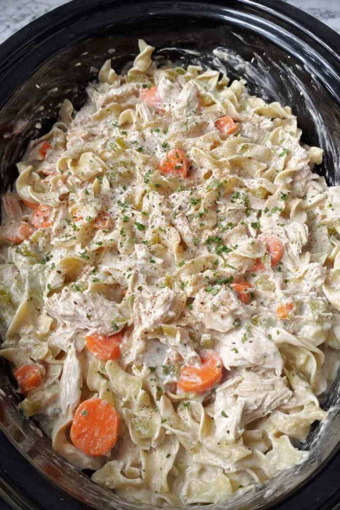 Crockpot creamy chicken and noodles in a white bowl