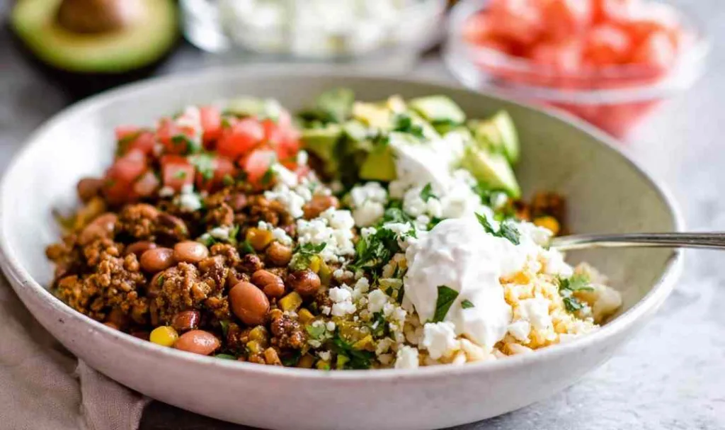 Ground turkey taco bowl with lime rice, avocado, queso fresco and sour cream