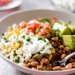Ground turkey taco bowl with lime rice, avocado, queso fresco and sour cream