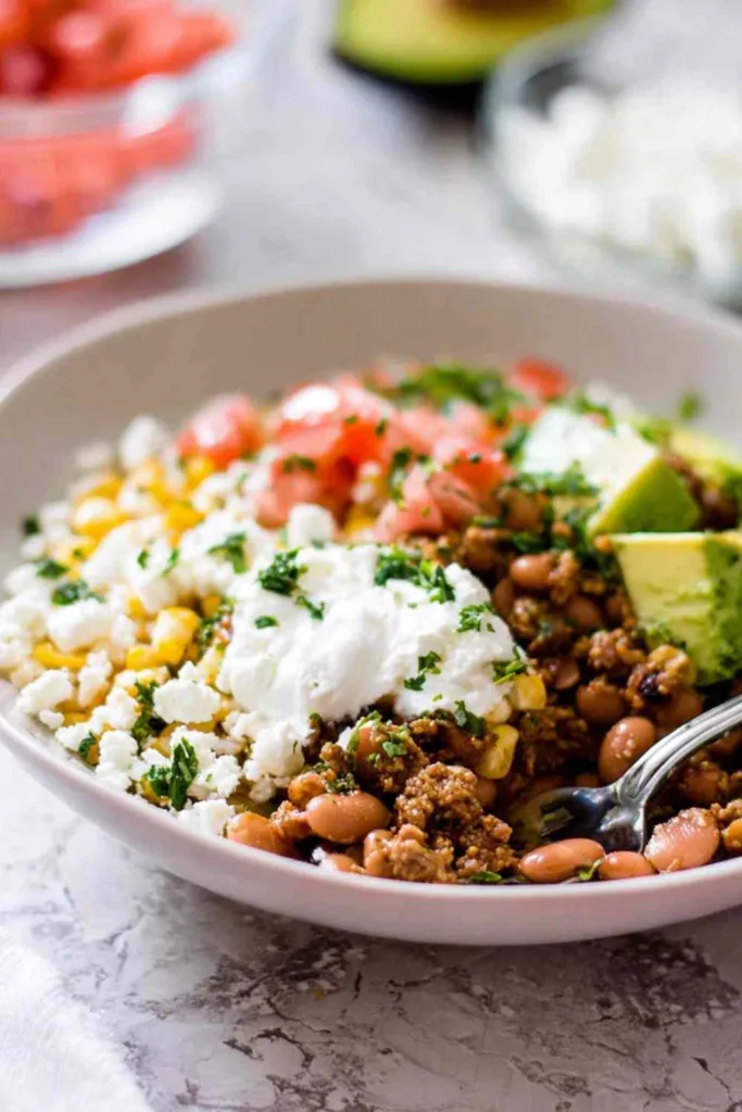 Ground turkey taco bowl with lime rice, avocado, queso fresco and sour cream