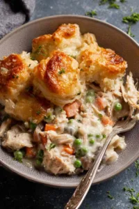 Leftover turkey pot pie with cheesy garlic bread topping in a cast iron skillet fresh from the oven