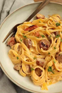 One Pot Creamy Cajun Sausage Pasta in a large skillet with colorful bell peppers and smoky sausage slices