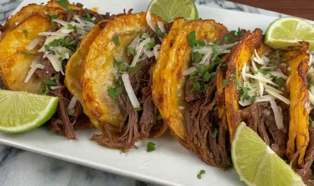 Street Corn Crockpot Shredded Beef Tacos on a white plate