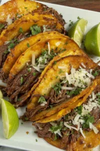 Street Corn Crockpot Shredded Beef Tacos on a white plate