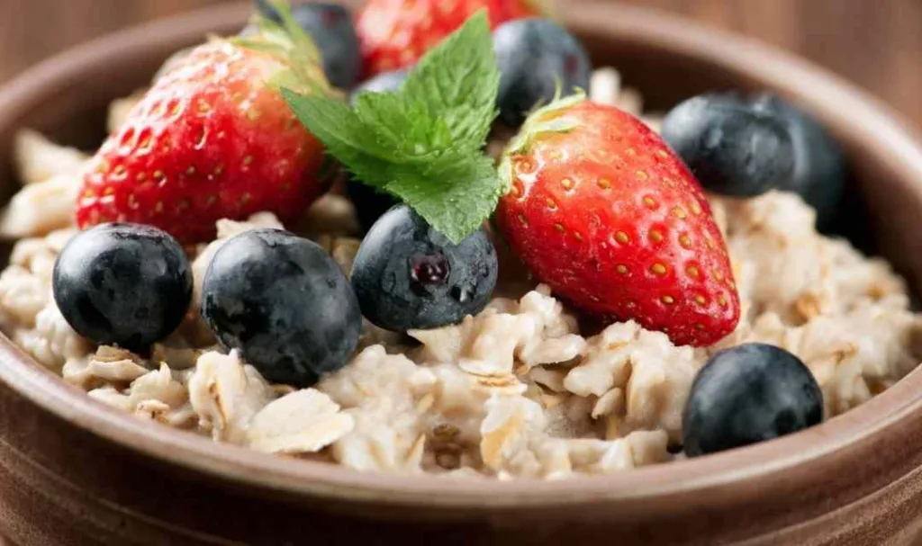 Superfood breakfast bowl slow cooker recipe topped with fresh berries and toasted almonds in a rustic bowl.