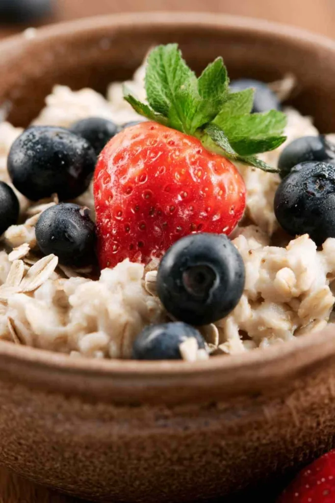 Superfood breakfast bowl slow cooker recipe topped with fresh berries and toasted almonds in a rustic bowl.