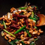 Thai cashew chicken stir fry served over jasmine rice in a white bowl