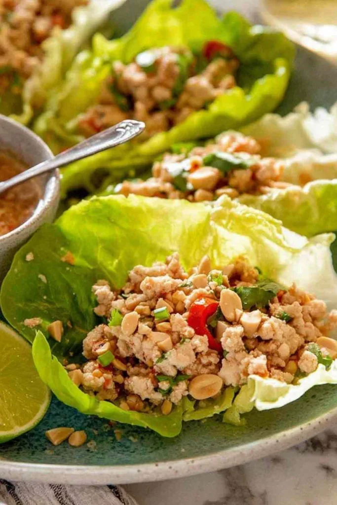 Thai lettuce wraps Larb Gai filled with spiced ground chicken, fresh mint, cilantro and crushed peanuts