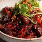 Vietnamese Caramel Ginger Chicken glazed chicken pieces served over jasmine rice with cilantro