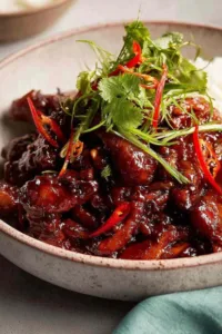 Vietnamese Caramel Ginger Chicken glazed chicken pieces served over jasmine rice with cilantro