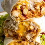 chicken burrito recipe cut in half showing juicy seasoned chicken refried beans and melted cheese