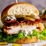 Crispy fried chicken burger stacked on a brioche bun with lettuce and pickles