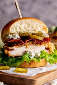 Crispy fried chicken burger stacked on a brioche bun with lettuce and pickles