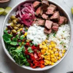 Steak bowl with garlic butter seared steak, rice, kidney beans, corn, tomato and mixed greens Filename: steak-bowl-recipe-garlic-butter.jpg
