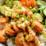 Bang Bang Shrimp Rice Bowl with crispy golden shrimp, avocado, edamame, carrots and bang bang sauce