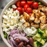 Chicken Gyro Bowl with marinated chicken, tzatziki sauce, crumbled feta, cherry tomatoes, kalamata olives, and brown rice