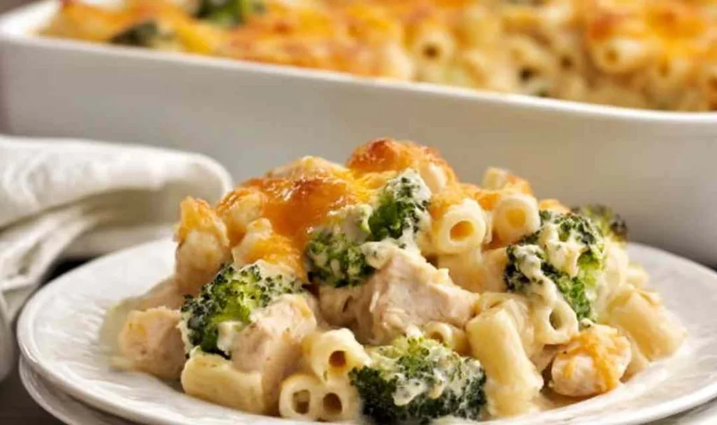 Chicken broccoli casserole with golden Panko cheddar topping fresh from the oven in a white casserole dish